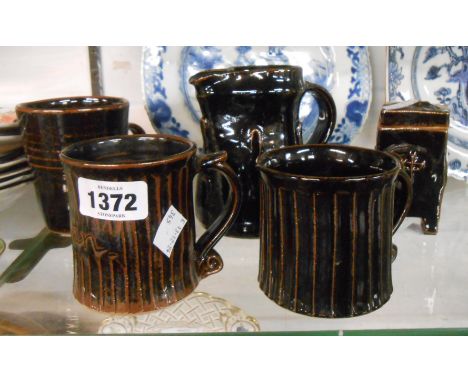 Five pieces of Jeremy Leach Lowerdown Studio Pottery comprising three mugs, a jug and a lidded jar - all decorated in 'Tenmok