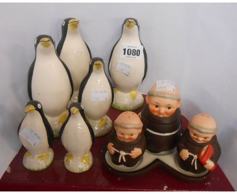 Six ceramic penguin figurines of various size - sold with a Goebel pottery cruet on stand, depicting stylized monks
