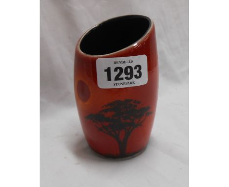 A small Poole Pottery vase with hand painted silhouette landscape decoration, on a red glazed ground