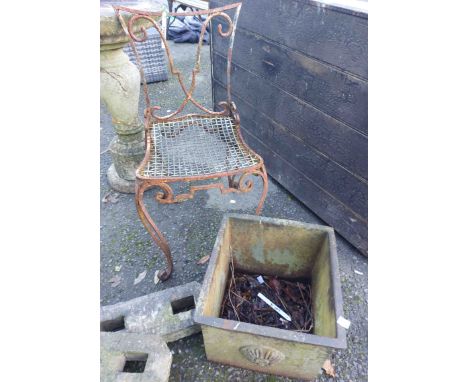 A cast iron planter - sold with a metal garden chair