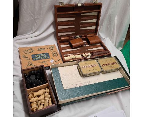 A small group of vintage games comprising Scrabble, backgammon, Chad Valley metal puzzles and a wooden chess set in slide-top