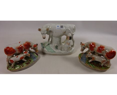 Staffordshire model of a milk maid with cow and a pair of Staffordshire type cow groups (3) Condition Report Click here for f