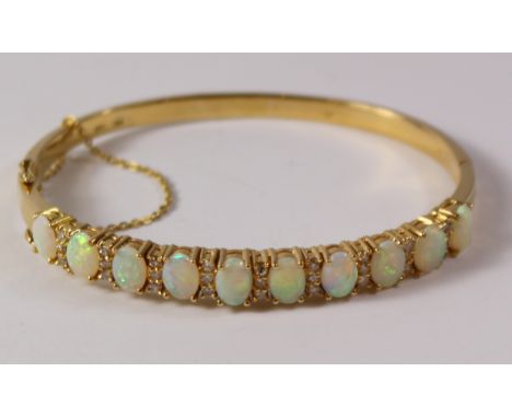 Gallery set opal and diamond hinged bangle comrising ten opals and twenty - seven diamonds stamped 750 18k Condition Report C