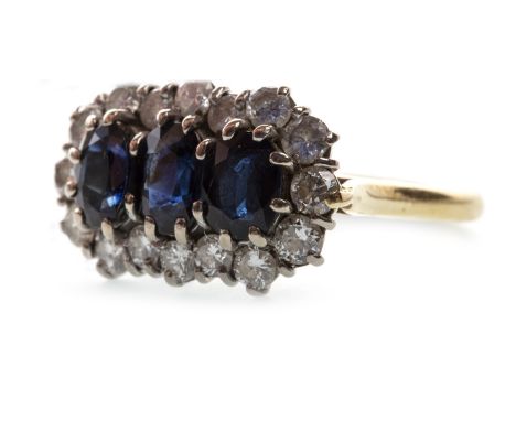 BLUE GEM AND DIAMOND CLUSTER RING, set with three central oval faceted blue gems within a diamond halo, in eighteen carat gol