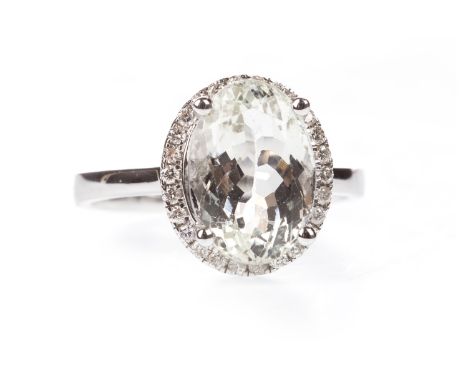 AQUAMARINE AND DIAMOND RING, the oval aquamarine of approximately 2.88 carats within a diamond halo, the round brilliant cut 