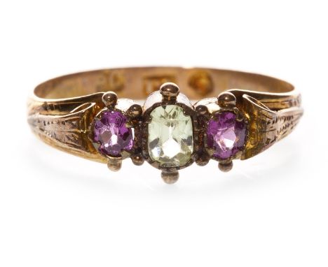 VICTORIAN GEM SET RING, set with a central faceted green gem flanked by two lilac gems, ornate scroll motif shoulders, marked
