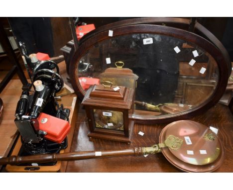 A mahogany cased striking bracket style clock; an oval mirror, bevelled edge, oak framed; a warming pan; a Singer sewing mach