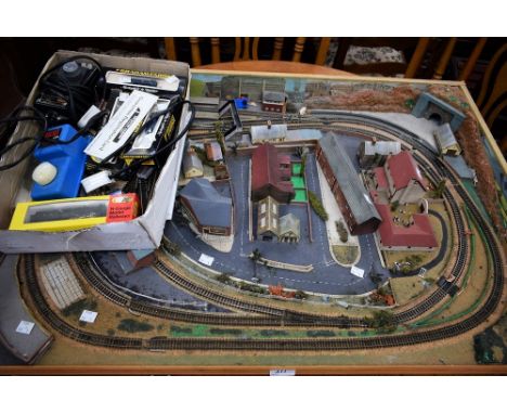 An 'N' gauge model railway layout on board with buildings, trees, etc; locomotives (5), carriages, wagons, power controllers,