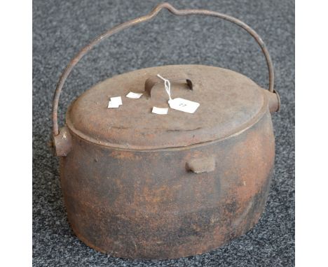 A vintage cast iron cooking pot 