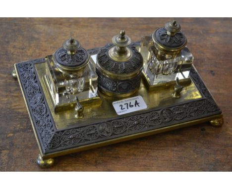 A 19th century gilt brass and electrotype rectangular standish, central cylindrical wafer box flanked by a pair of square gla