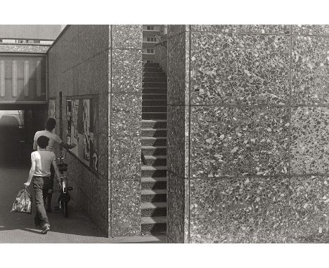 Wüst, Ulrich -- Street corner. 1980s. Vintage gelatin silver print. 14,5 x 21,8 cm (24 x 29,8 cm). With the photographer's st