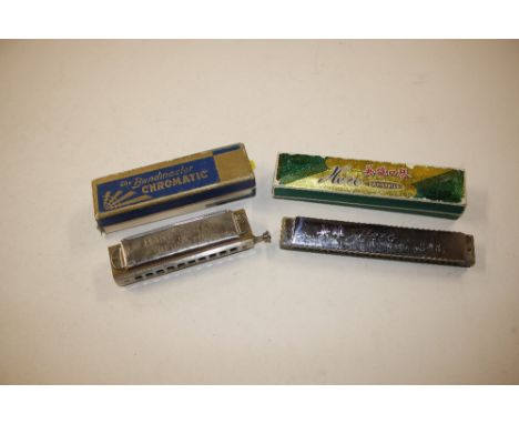 A boxed "The Bandmaster Deluxe Chromatic Harmonica"; and one other