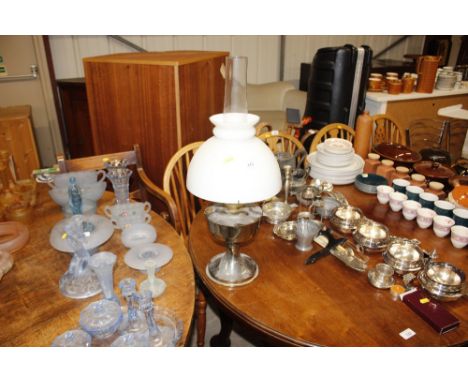 An oil lamp with milk glass shade and glass chimney