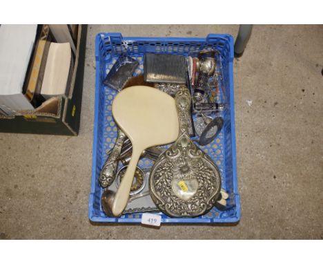 A tray box and contents of various silver plated items to include salt, pepper ladle, embossed hand mirror, cigarette case et