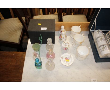 A quantity of Royal Crown Derby items to include a salt and pepper pot, cups, pin dish; and a quantity of scent bottles to in