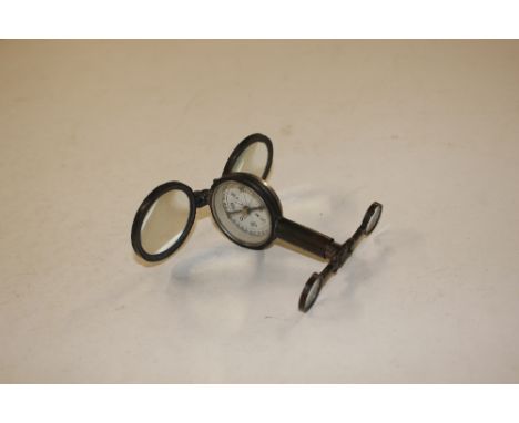A mid 20th Century military compass with pull out handle, two attached magnifiers and a mirror to base