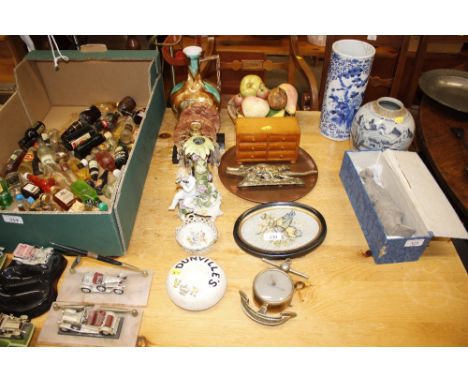 A quantity of various decorative items to include a candlestick decorated with a cherub, a nut cracker in the form of an alli