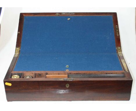 An early 19th century mahogany campaign writing slope of typical rectangular form, the hinged lid opening to reveal baize lin
