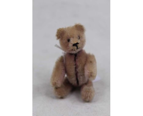 A novelty Schuco - early 20th century picture locket compact in the form of a teddy-bear, the pink plush bear having removabl