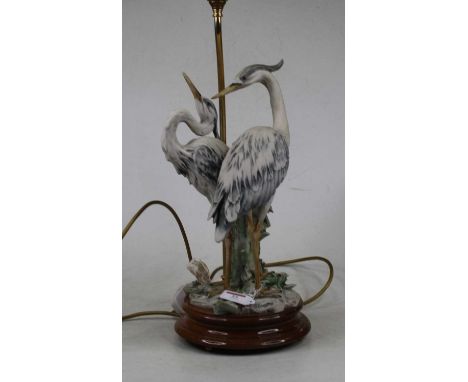 An Italian table lamp modelled as two herons upon a turned beech plinth, height 68cm including fittingsCondition report: No s