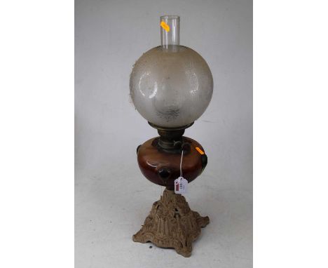 A Victorian pedestal oil lamp, having etched opalescent globular shade above a glass font, on cast iron base, h.52cm