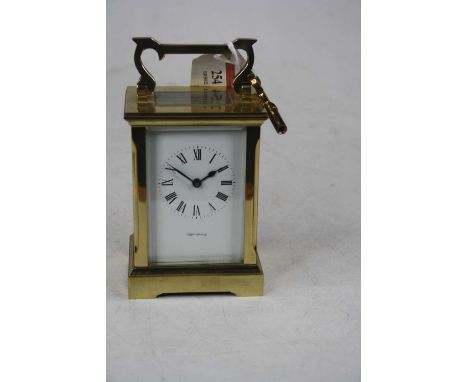 A 20th century lacquered brass cased carriage clock, having an enamel dial with Roman numerals signed Mappin &amp; Webb Ltd, 