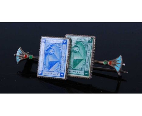 An early 20th century French Egyptian Revival base metal and enamel bar brooch, arranged as two stamps, 43mm in fitted box