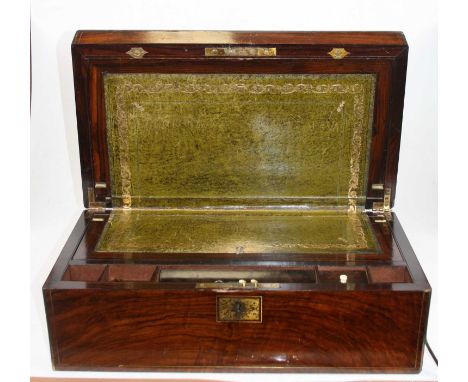 A Victorian walnut and brass inlaid writing slope, the lid lifting to reveal a fitted interior with gilt tooled green leather