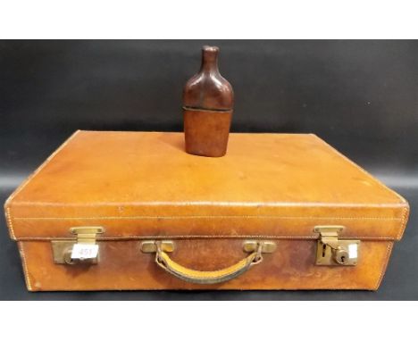 A tan leather suitcase by Army & Navy Stores, London; together with a leather covered glass hip flask (2)