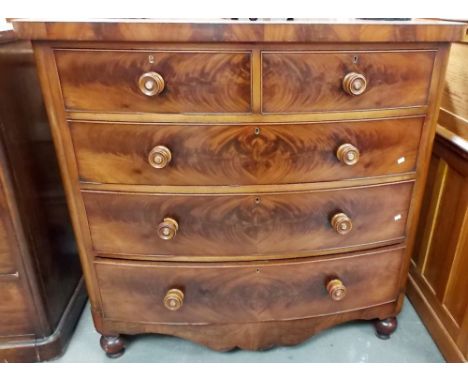 Victorian mahogany veneered bow front chest of two short over two long graduated drawers with a shaped apron and on turned fe