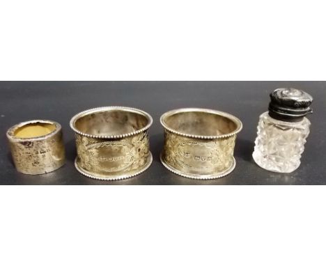 Pair of Victorian foliate engraved napkin rings, Chester 1901; together with a small silver lidded cut glass scent bottle and