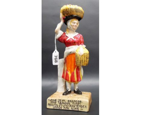 A rare Clarice Cliff Wilkinson Ltd figure of a lady with a basket or oranges on her head, the base inscribed 'Fine Seville Or