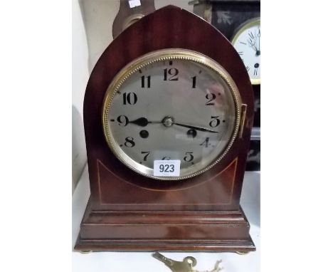 Two train mantel clock with mahogany inlaid lancet case, the silvered dial with Arabic numerals, the French movement striking