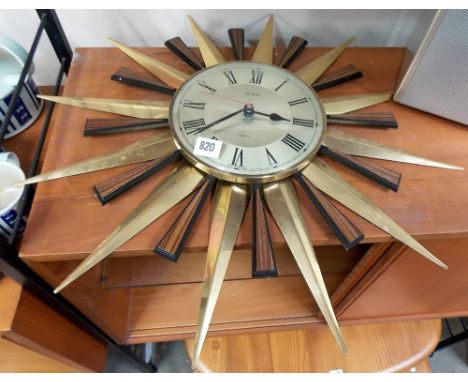 Metamec quartz brass and teak sunburst wall clock.