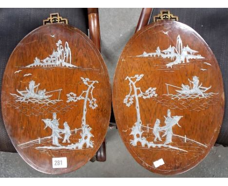 Pair of Chinese silver inlaid hardwood oval wall plaques, both decorated with figures in gardens, fishermen and pagoda buildi