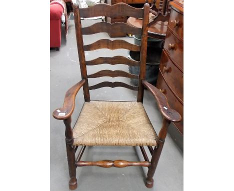 19th Century elm Lancashire ladder back elbow chair with rush covered seat, height 43.5'.