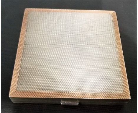 Silver and rose gold compact of square form with engine turned decoration, Birmingham 1943.