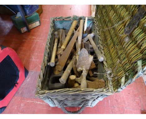 Wicker basket containing large quantity of hand tools including trowels, hammers, saws, files etc