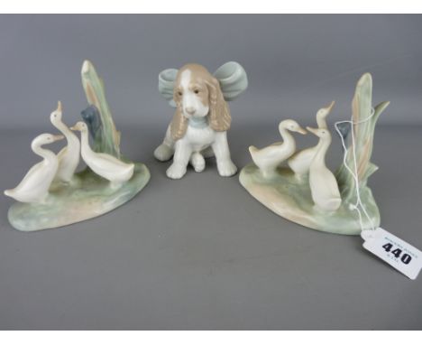 Two Nao porcelain groups of ducks and a seated spaniel with a big bow