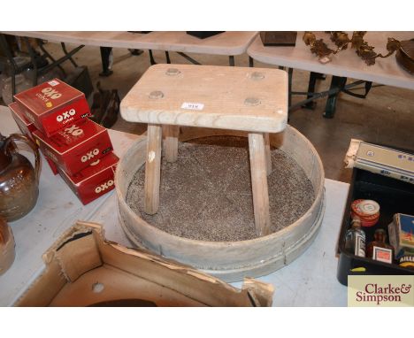 A vintage rustic pine stool and a garden sieve