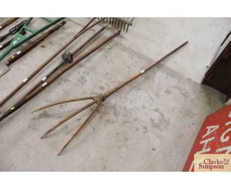 A vintage wooden three pronged hay fork