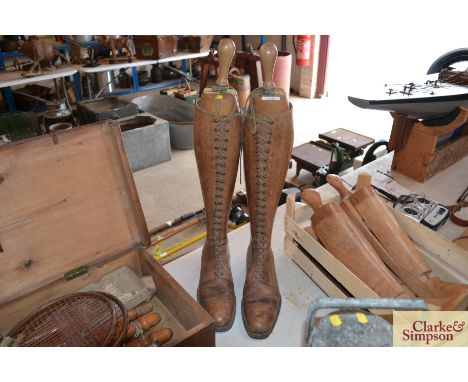 A pair of early 20th Century vintage leather boots complete with wooden boot trees