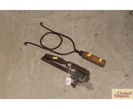 A vintage horse gag with turned wooden handle and an old trap