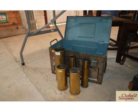 Five various brass shell cases and an ammunition box 