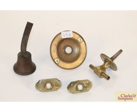 A large brass circular bell push with ceramic button, two smaller matching bell pushes, a Victorian brass hand shaped safe ha