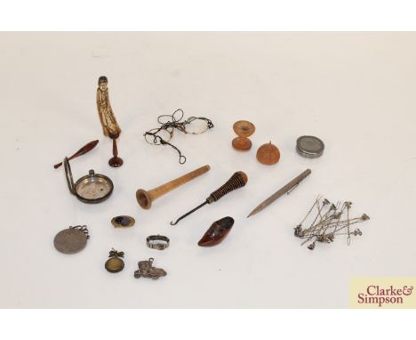 A box containing miniature Treen items, pewter snuff box, medallion, silver watch case etc.