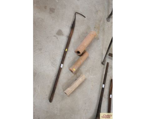 A drainage laying tool and three Roman and other terracotta drainage pipes