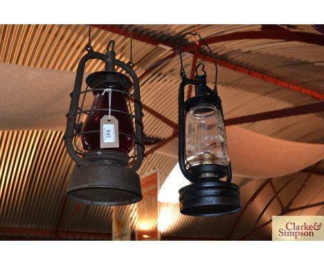 Two vintage Hurricane lamps, one clear glass and one ruby glass 