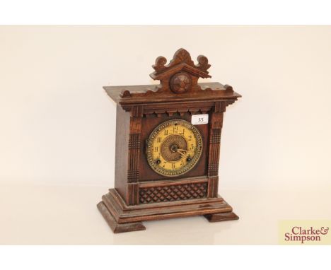 A continental oak cased striking mantel clock 