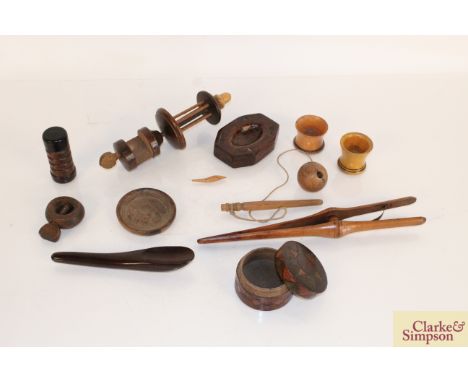 A box of miscellaneous antique Treen including screw hazelnut cracker, a small wine glass coaster, a pair of glove stretchers